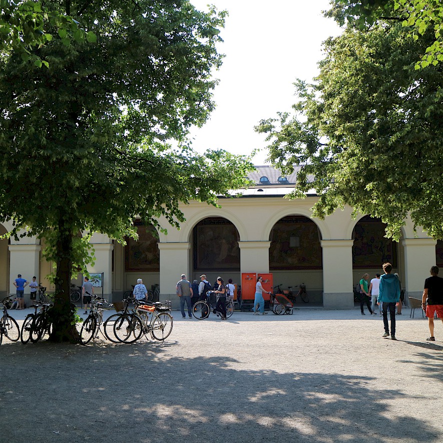 People gather in front of the Hofgarten arcades