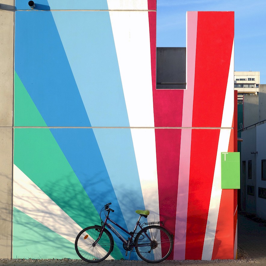 Bicycle in front of a colourful painted wall