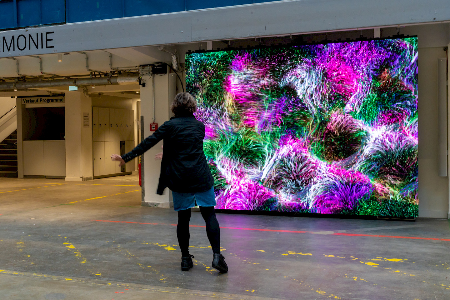 Someone activates the colored LED wall with body movements.