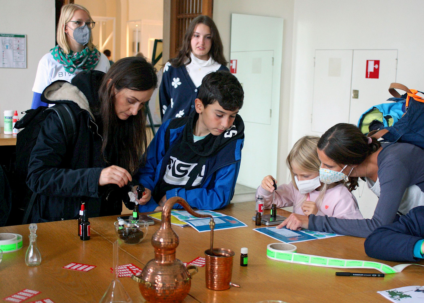 Visitors create their own fragrances in the smell lab with pipettes and instruments