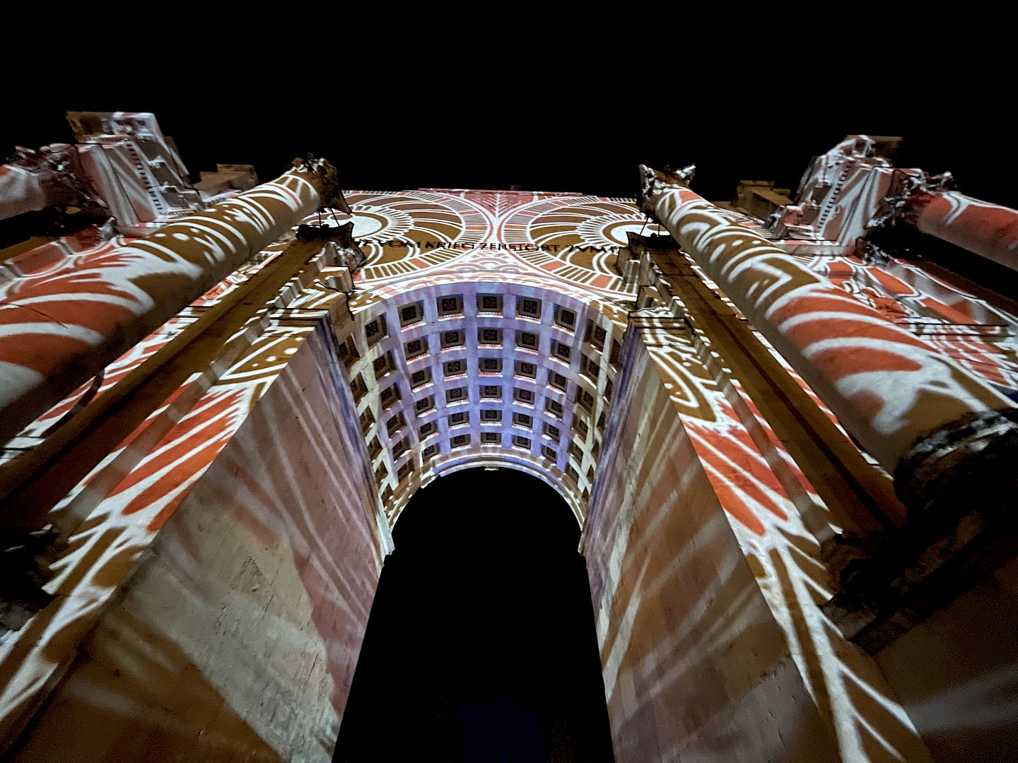 The colorful patterns projected onto the large Siegestor Monument are impressive and colorful in the dark.
