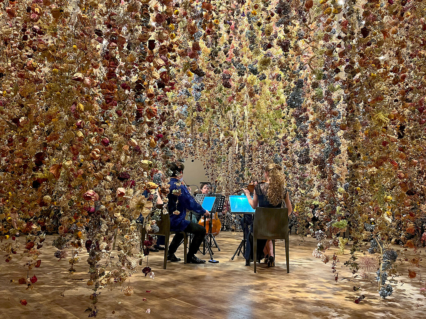 Musicians inside the floral installation "Calyx" by Rebecca Louise Law