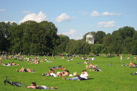Lawn for sunbathing in the English Garden with the Monopterus temple.