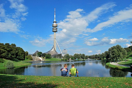 Two boys sitting in front of the Olympic lake