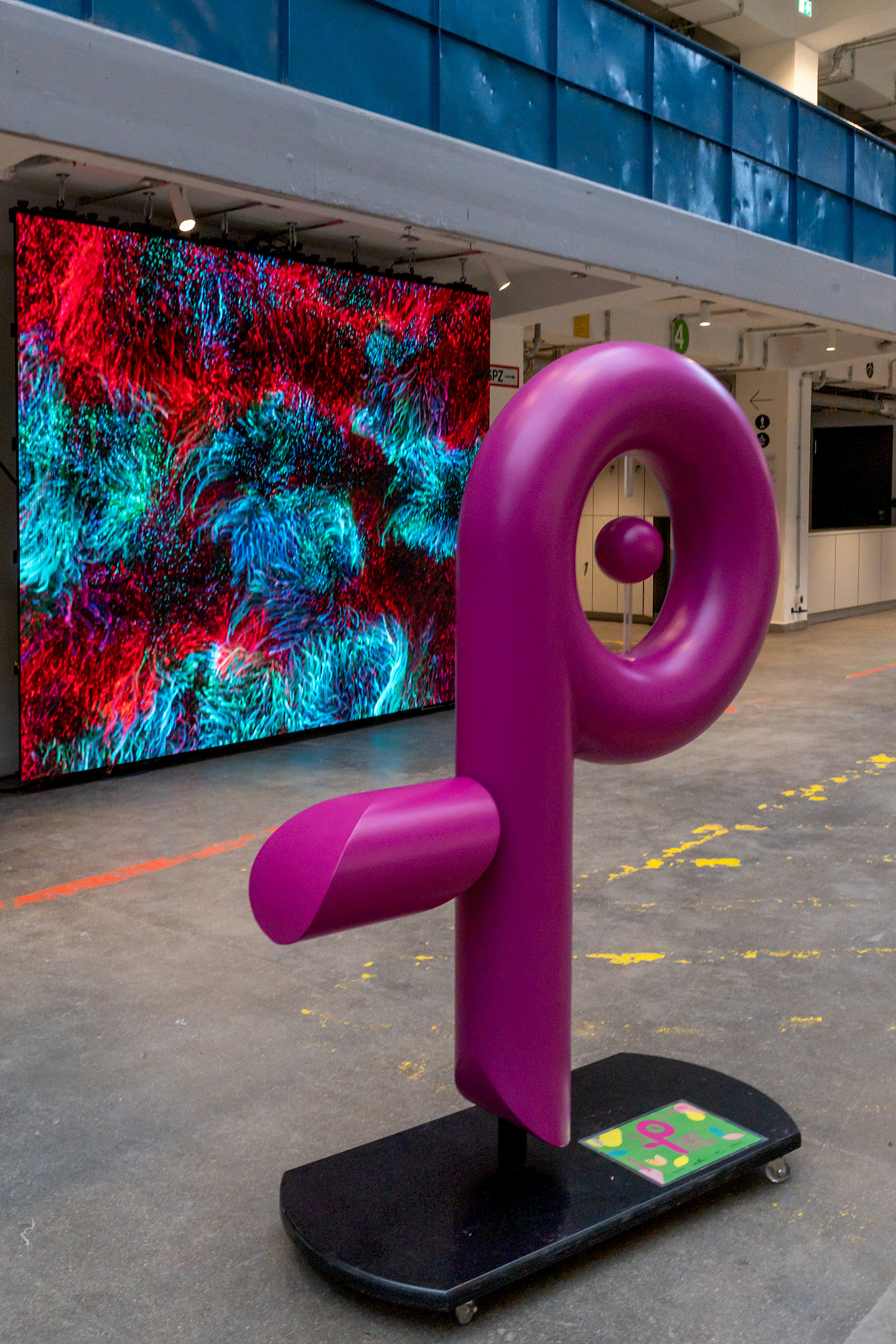 The flower power symbol stands in front of the interactive LED wall.